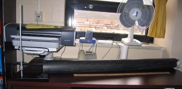 Apparatus for measuring the speed of sound. Note the microphone mounted on the lab stand, located just left of the plastic pipe.